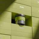 A cylindrical jar labeled Amíu sits in a recessed slot between matching green boxes, with the brand name repeated on the surrounding packaging.