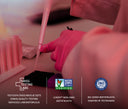 A close-up of a person wearing pink gloves and a pink coat using a pipette over a sample well, with Swiss Testing Labs branding and non-GMO/ISO certification logos overlaid at the bottom.